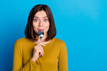 Sticker - Photo of shiny excited lady dressed shirt licking spoon felling hungry empty space isolated blue color background