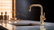 © Nico - close up of a shiny gold faucet rectangular sink