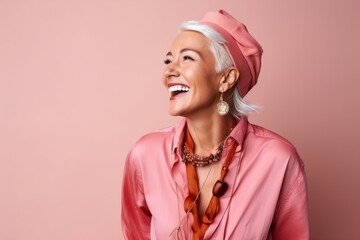 Poster - smiling senior woman in pink jacket and beret over pink background