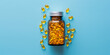 Yellow vitamin pills in bottle on blue background studio