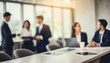 © Your Hand Please - Blurry office meeting scene symbolizing business dynamics, with copy space