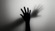 © Vladimir - Hand silhouette on grey background. Blurred human hand shape out of focus
