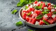 A creative watermelon and feta salad with mint leaves and a balsamic reduction