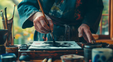Hands, Brush In Ink For Writing And Japanese Calligraphy Or Ancient Script For Art And Inkstone. Asian Creativity, Black Paint And Vintage Tools, Paintbrush And Person With Traditional Stationery