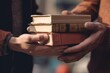 close up hands exchange a stack of well worn books, a silent testament to the shared love of reading and the diverse stories that bind us