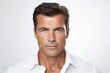 © Iigo - Closeup portrait of handsome mature man in white shirt, studio shot