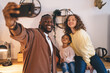 © BullRun - Cheerful multiethnic family taking selfie together
