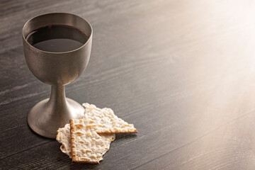 Wall Mural - Holy Communion in a Pewter Goblet with an Antique Bible on a Wooden Table