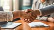 © Alin - two people shaking hands for a business deal