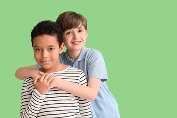 Sticker - Cute little boys hugging on green background