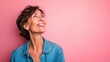© buraratn - Middle age beautiful woman wearing casual denim shirt standing over pink background looking away to side with smile on face