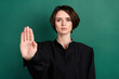 © deagreez - Photo of serious beautiful attractive woman judge attorney showing no stop sign gesture isolated on green color background