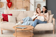 © Pixel-Shot - Young lesbian couple resting at home on Valentine's Day