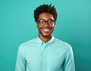 Wall Mural - Portrait of young smiling man wearing glasses isolated on turquoise background with space for inscriptions or text.generative ai