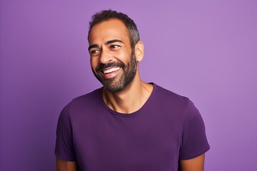 Portrait of happy african american man with beard on violet background