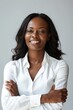 © Barbara Taylor - Portrait of handsome smiling 40 year old black female business woman with folded arms