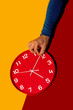 © ADDICTIVE STOCK - Hand adjusting a red clock on a colorful background
