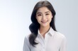 © Surachetsh - A hyper-realistic 3D model depicts a young, cute Asian businesswoman standing with a smile in an office attire against an isolated white background. Generative AI.