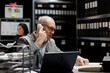 © DC Studio - Accounting elderly businessman offering consultancy during phone call in bookkeeping workplace. Professional senior employee in archival depository filled with document folders and flowcharts