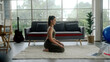 Asian woman practicing yoga at home