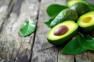 Wall Mural - Healthy green avocados on a wooden table a wide banner idea