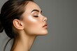 © LimeSky - Young woman with smooth and healthy skin profile view over gray background focused on facial and neck skincare