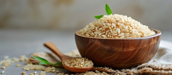 Poster - Isolated copy of brown rice on wooden bowl and wooden spoon, quickly.