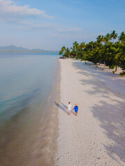 Wall Mural - Koh Mook Drone view at a couple walking on the white sandy tropical beach of Koh MukThailand