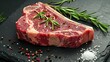 © Jennifer - Dry-aged Raw T-bone or porterhouse beef steak with herbs and salt. On a black stone background. Barbecue