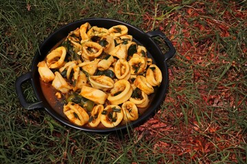 Wall Mural - Indian Spicy Squid Masala. Konkani Calamari Dry. Main Course Seafood recipes. Tender squid cooked with aromatic spices like cumin, coriander, and chili powder, sautéed with onions and garlic.