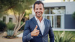 © Nick - Male Real Estate Agent or broker with welcoming thumbs up gesture and show clients around properties