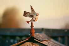 Rustic Charm Of Weathered Wind Vane, Sunset's Golden Hue