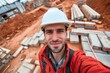 selfie of worker with hard hat in front of bricklaying work