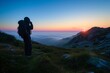 © primopiano - hiker capturing the first light at dawn