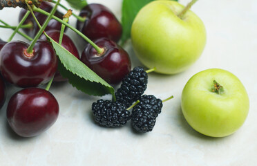 Wall Mural - Red cherries and fruits on white mar