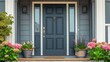 Gray front door with small square decorative windows and flower pots in front of it