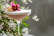 closeup of a sophisticated cocktail garnished with a floral arrangement