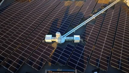 Wall Mural - Aerial drone view of solar panels at sunset. Photovoltaics on top of the roof of the building. Alternative electricity source. Concept of sustainable resources