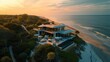 © visoot - Modern beach front 3-story home with large glass windows. Aerial high view. Generative AI.