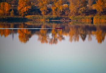 glare and reflections on the water. the sky is reflected in the water. Background of waves, reflections, refractions and abstract diffractions, in the blue, clean and crystalline water. trees are refl