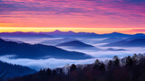 Fototapeta Góry - A frosty January sunrise over a mountain range, with hues of pink and orange in the sky