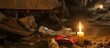 Candle with miner's belongings placed in vigil light after deadly mine accident.