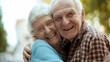 © MYDAYcontent - An older couple sharing a warm embrace while standing outside, showing their love and affection for each other.