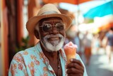 smiling retired man with summer clothes, eating an ice cream in a summer day