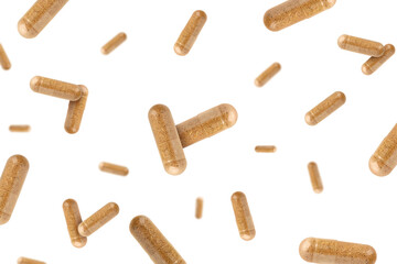 Wall Mural - Vitamin. Many capsules falling on white background