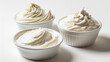 Three Small White Bowls Filled with Whipped Cream