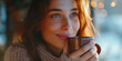 © Erzsbet - Beautiful woman smiling and hold a mug of hot drink coffee or tea with morning light cozy feeling on a winterday