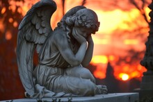 Contemplative Angel Statue At Sunset: Symbol Of Grief And Remembrance With A Vibrant Sky In The Background
