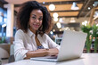 © Lucy Welch - :Confident Young African American Woman Working on Laptop