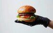 © imagineRbc - Multiracial Hand Holding a Hamburger